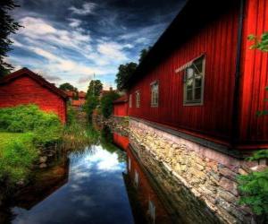 yapboz Kırmızı evler bir kanal yanında